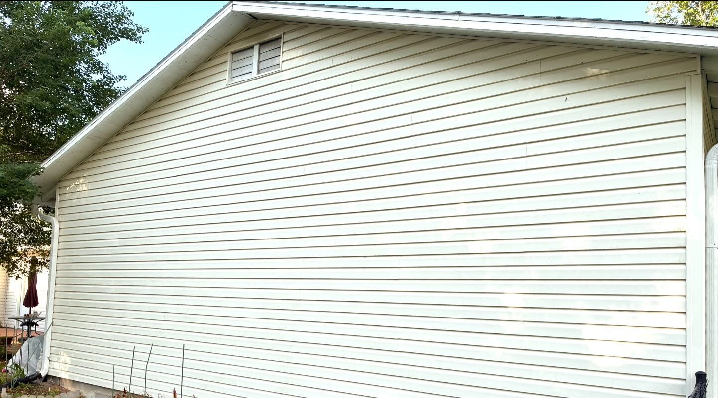 The same siding after a soft wash, back to a clean even cream with no algae left