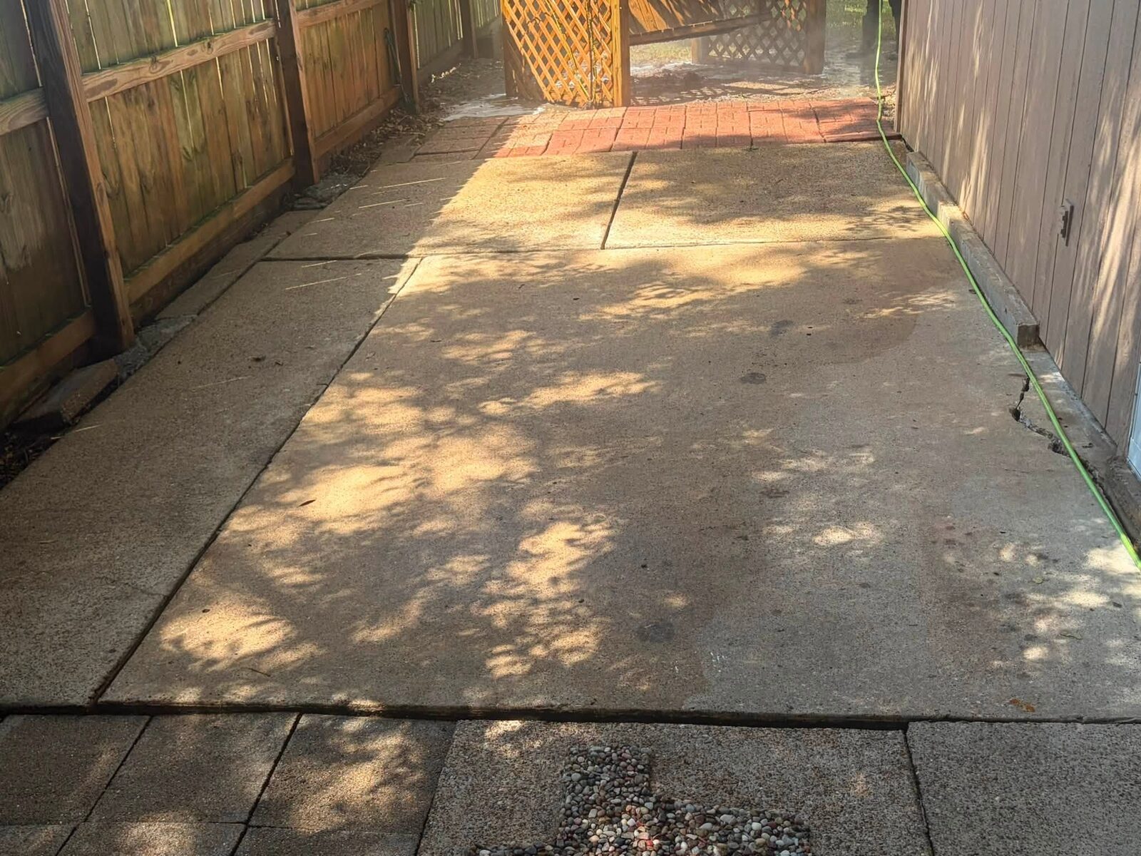 The same patio washed to a clean pale tan concrete, edge to edge