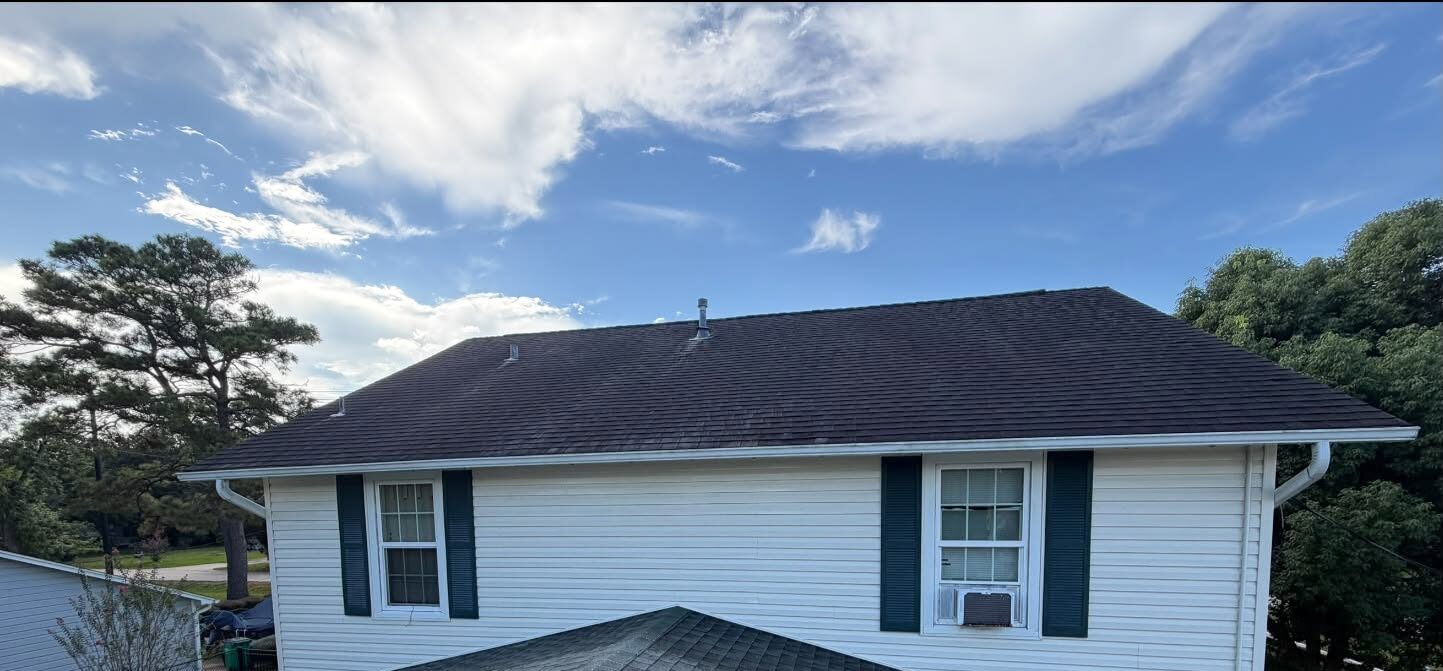 The same house from above after washing, the siding bright white and the roof clean